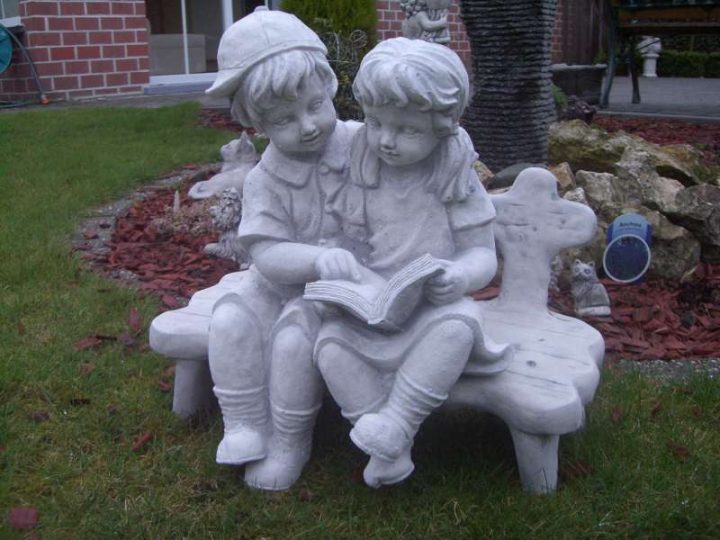 Tuinbeelden Kindjes op bank met boek 